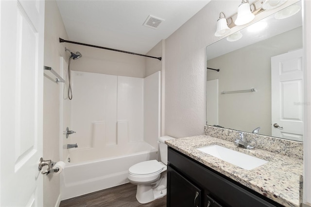6561 SW 129th Loop, Ocala, FL 34473 - bathroom featuring vanity, wood finished floors, toilet, and tub / shower combination