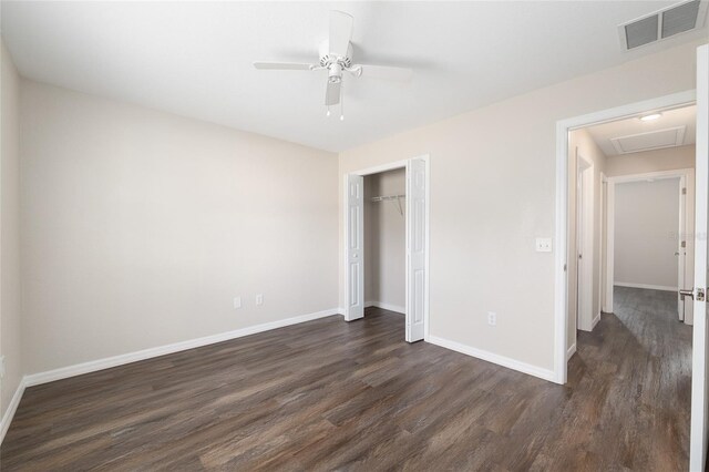 6561 SW 129th Loop, Ocala, FL 34473 - unfurnished bedroom with dark wood-style floors, baseboards, a closet, ceiling fan, and attic access
