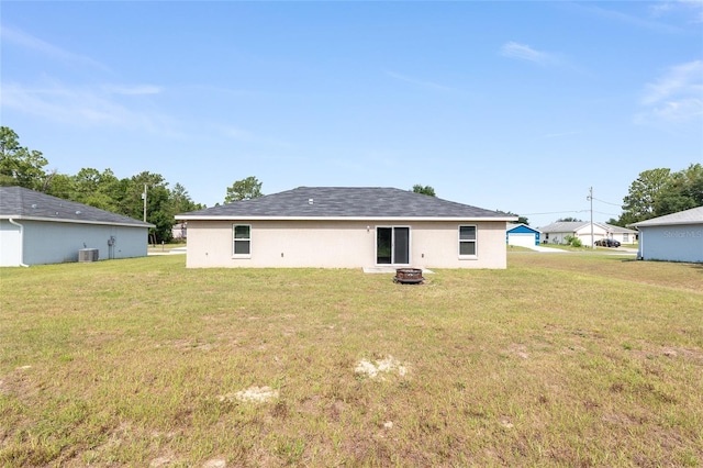 6561 SW 129th Loop, Ocala, FL 34473 - back of house featuring a yard, a fire pit, and central air condition unit