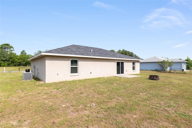 6561 SW 129th Loop, Ocala, FL 34473 - back of house featuring central AC and an outdoor fire pit