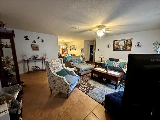 27 Cedar Tree Ter, Ocala, FL 34472 - living room featuring ceiling fan, a textured ceiling, a chandelier, and tile patterned floors