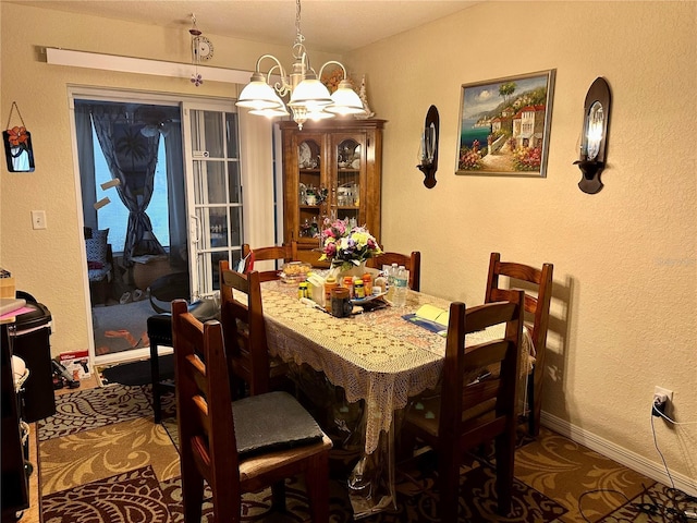 27 Cedar Tree Ter, Ocala, FL 34472 - dining area featuring a chandelier, a textured wall, and baseboards