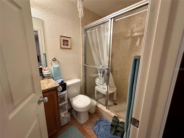27 Cedar Tree Ter, Ocala, FL 34472 - full bath with toilet, a shower stall, vanity, tile patterned floors, and a textured wall