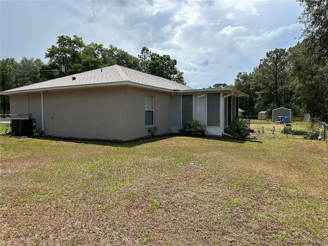 27 Cedar Tree Ter, Ocala, FL 34472 - rear view of property featuring central AC, a sunroom, and stucco siding