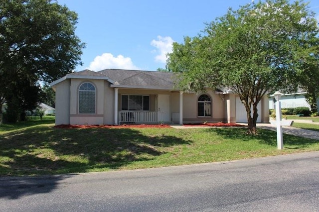 5110 NW 19th Pl, Ocala, FL 34482 - single story home with a front yard, an attached garage, a porch, stucco siding, and driveway