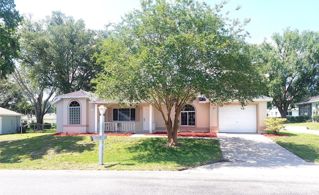 5110 NW 19th Pl, Ocala, FL 34482 - view of front facade with stucco siding, a porch, an attached garage, a front lawn, and concrete driveway