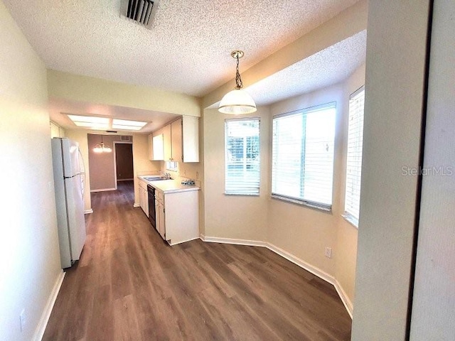 5110 NW 19th Pl, Ocala, FL 34482 - kitchen with freestanding refrigerator, a sink, a textured ceiling, baseboards, and light countertops