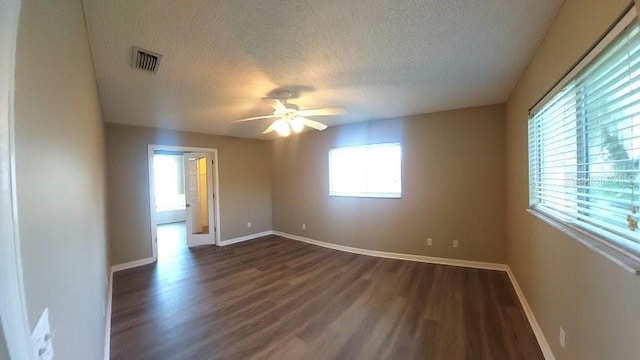 5110 NW 19th Pl, Ocala, FL 34482 - empty room with a textured ceiling, dark wood finished floors, a ceiling fan, and baseboards