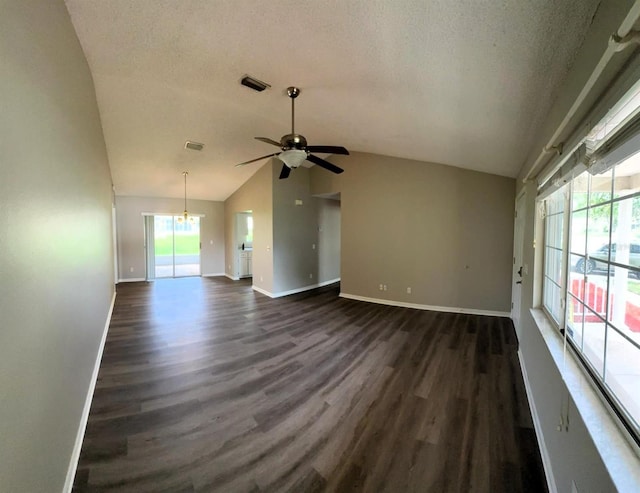 5110 NW 19th Pl, Ocala, FL 34482 - unfurnished living room with vaulted ceiling, dark wood finished floors, ceiling fan, baseboards, and a chandelier