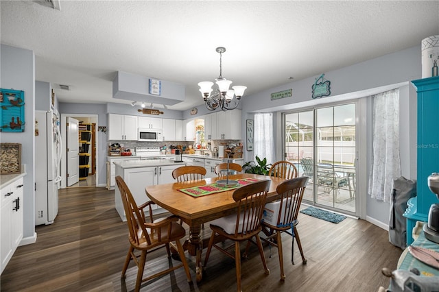 6070 SE 39th Ave, Ocala, FL 34480 - dining space with a chandelier, dark wood-style floors, and baseboards