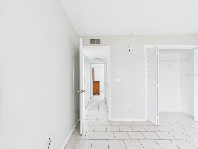1801 Caralee Blvd Unit 2, Orlando, FL 32822 - unfurnished bedroom featuring a closet, light tile patterned floors, and baseboards