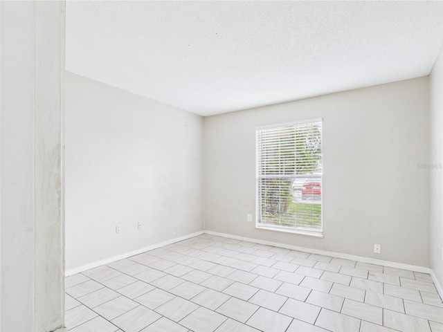 1801 Caralee Blvd Unit 2, Orlando, FL 32822 - spare room featuring baseboards and a textured ceiling