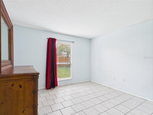 1801 Caralee Blvd Unit 2, Orlando, FL 32822 - spare room with a textured ceiling and baseboards