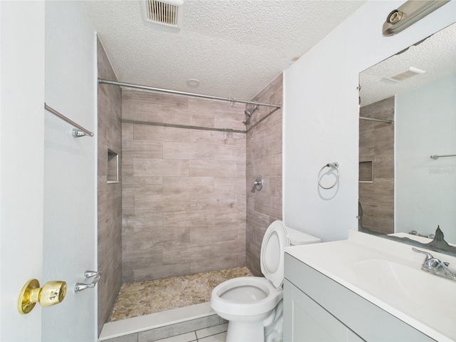 1801 Caralee Blvd Unit 2, Orlando, FL 32822 - bathroom with vanity, toilet, a textured ceiling, a tile shower, and tile patterned floors