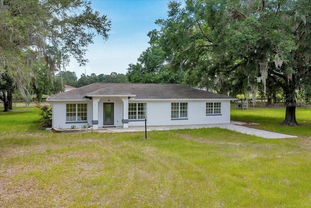 6350 NW 135th Ave, Morriston, FL 32668 - single story home with a front lawn, stucco siding, and view of scattered trees