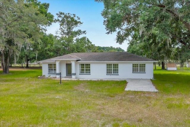 6350 NW 135th Ave, Morriston, FL 32668 - back of house featuring a yard, stucco siding, and a patio