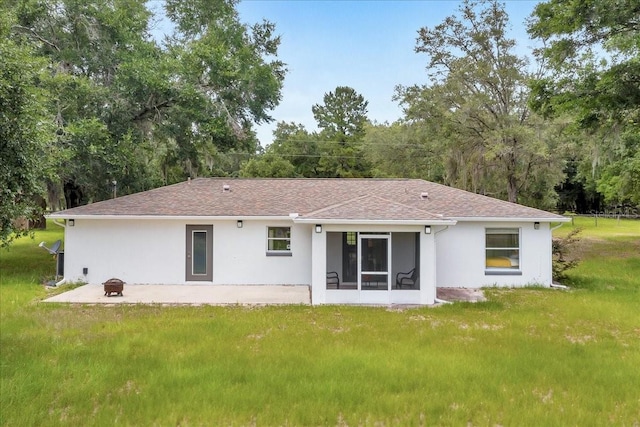 6350 NW 135th Ave, Morriston, FL 32668 - rear view of house featuring stucco siding, a fire pit, and a yard