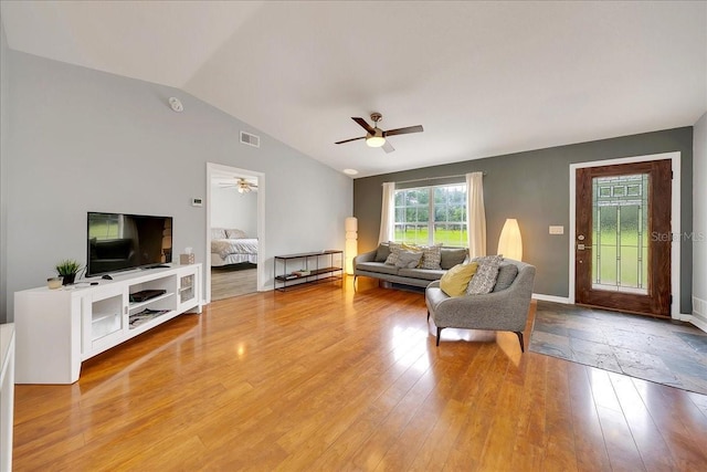 6350 NW 135th Ave, Morriston, FL 32668 - living area featuring vaulted ceiling, a ceiling fan, light wood-type flooring, and baseboards