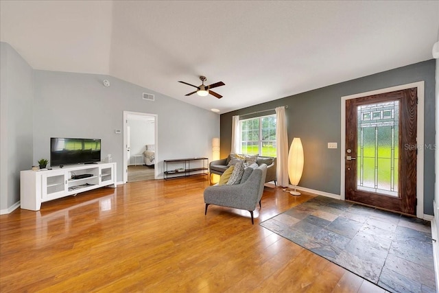 6350 NW 135th Ave, Morriston, FL 32668 - living room featuring vaulted ceiling, a ceiling fan, baseboards, and wood finished floors