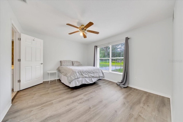 6350 NW 135th Ave, Morriston, FL 32668 - bedroom with light wood-style floors, baseboards, and ceiling fan