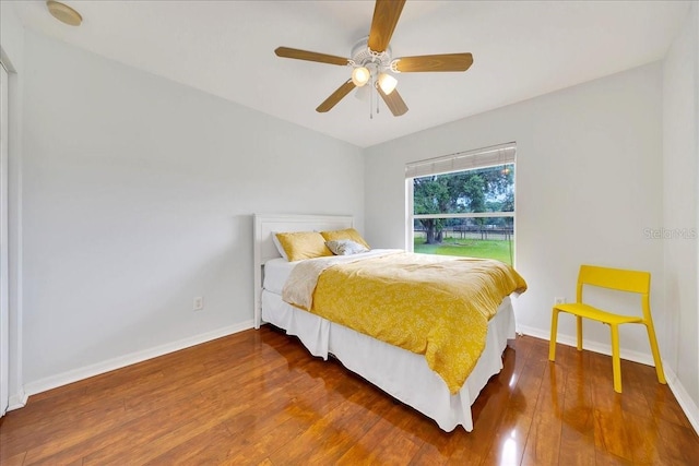 6350 NW 135th Ave, Morriston, FL 32668 - bedroom featuring wood finished floors, baseboards, and a ceiling fan