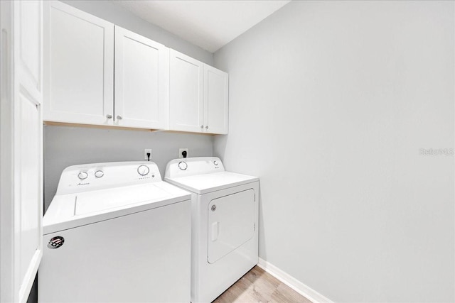 6350 NW 135th Ave, Morriston, FL 32668 - laundry room featuring washing machine and dryer, cabinet space, light wood-style floors, and baseboards