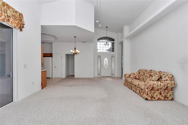 11062 SW 73rd Ct, Ocala, FL 34476 - entrance foyer featuring light carpet, a chandelier, a towering ceiling, and baseboards