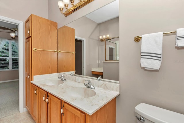 11062 SW 73rd Ct, Ocala, FL 34476 - bathroom with double vanity, toilet, a chandelier, tile patterned flooring, and baseboards