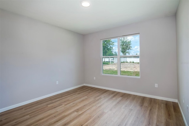 10207 SW 41st Ter W, Ocala, FL 34476 - empty room with wood finished floors and baseboards