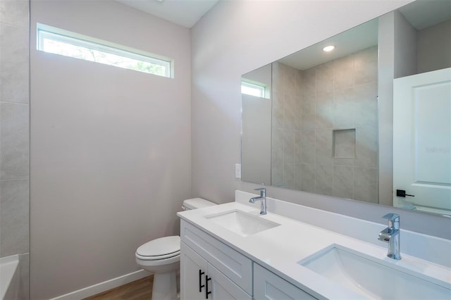 10207 SW 41st Ter W, Ocala, FL 34476 - bathroom with double vanity, a tub to relax in, wood finished floors, and a shower
