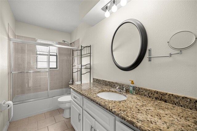 5720 SE 20th St, Ocala, FL 34480 - bathroom with vanity, toilet, combined bath / shower with glass door, and tile patterned floors