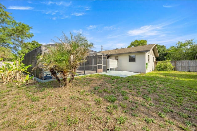 5720 SE 20th St, Ocala, FL 34480 - rear view of property featuring a patio, stucco siding, and glass enclosure
