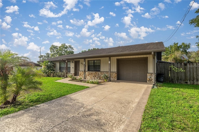 5720 SE 20th St, Ocala, FL 34480 - ranch-style house with an attached garage, concrete driveway, and stone siding