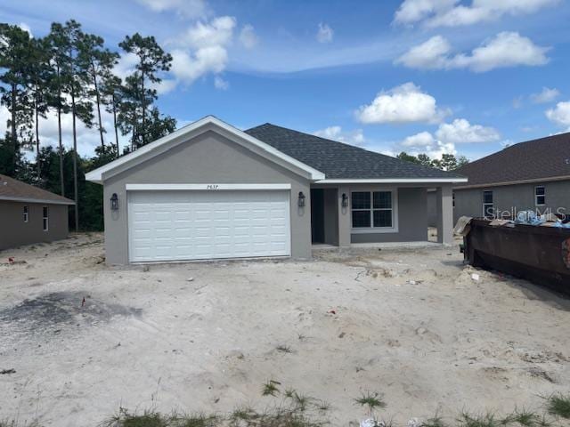 7637 SW 180th Cir, Dunnellon, FL 34432 - ranch-style home with stucco siding, a garage, and roof with shingles