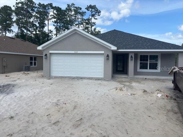 7637 SW 180th Cir, Dunnellon, FL 34432 - ranch-style home featuring an attached garage, stucco siding, central AC, a shingled roof, and driveway
