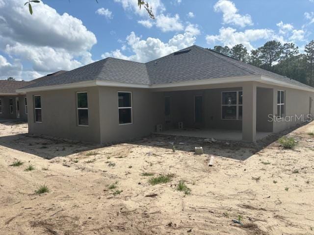 7637 SW 180th Cir, Dunnellon, FL 34432 - back of property with a patio, stucco siding, and roof with shingles