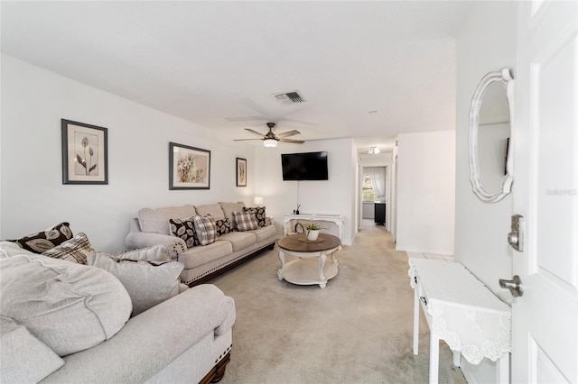 2701 NE 10th St Unit 101, Ocala, FL 34470 - living area with light carpet and a ceiling fan