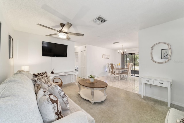2701 NE 10th St Unit 101, Ocala, FL 34470 - living room with a chandelier, light carpet, a ceiling fan, and baseboards