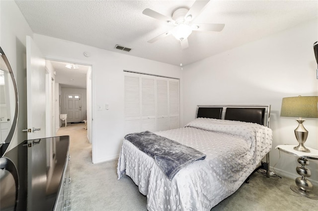 2701 NE 10th St Unit 101, Ocala, FL 34470 - bedroom featuring light carpet, a closet, baseboards, and a ceiling fan