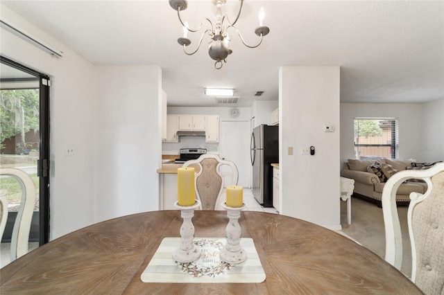 2701 NE 10th St Unit 101, Ocala, FL 34470 - dining area featuring a chandelier