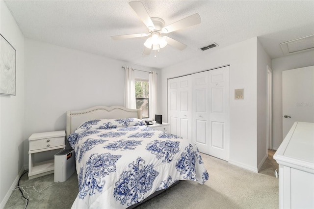 2701 NE 10th St Unit 101, Ocala, FL 34470 - bedroom with light carpet, a closet, a textured ceiling, baseboards, and a ceiling fan