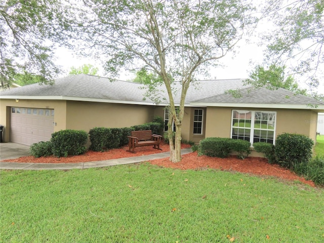 5083 SE 26th St, Ocala, FL 34480 - ranch-style home featuring an attached garage, a front yard, roof with shingles, and stucco siding