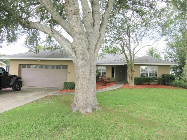 5083 SE 26th St, Ocala, FL 34480 - view of front of property featuring stucco siding, a front yard, a garage, driveway, and roof with shingles