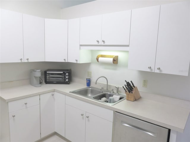 5083 SE 26th St, Ocala, FL 34480 - kitchen with a sink, dishwasher, light countertops, and white cabinets