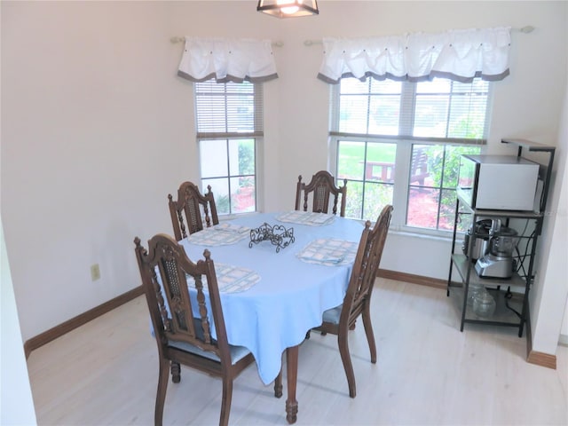 5083 SE 26th St, Ocala, FL 34480 - dining space with baseboards, plenty of natural light, and light wood-style floors
