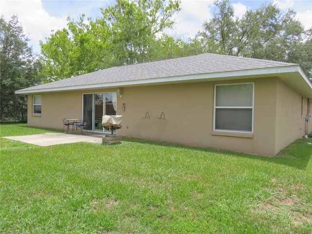 5083 SE 26th St, Ocala, FL 34480 - rear view of property featuring a patio, stucco siding, a lawn, and a shingled roof