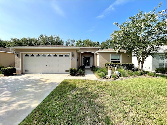 16405 SW 14th Avenue Rd, Ocala, FL 34473 - ranch-style house with a garage, driveway, stucco siding, and a front lawn