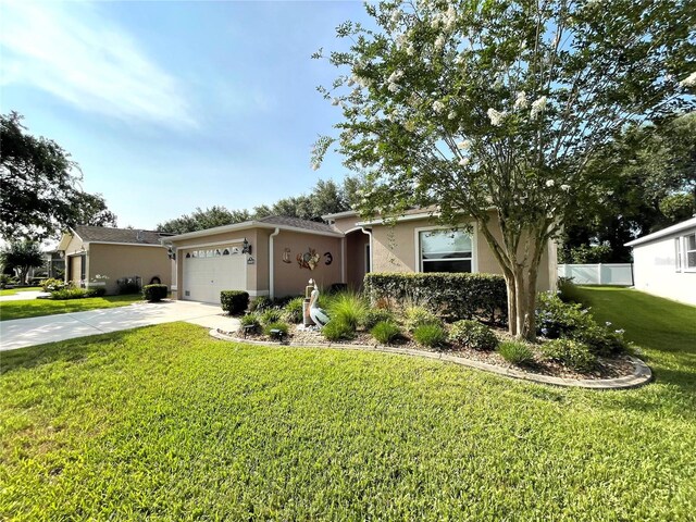 16405 SW 14th Avenue Rd, Ocala, FL 34473 - view of front facade featuring stucco siding, driveway, and a garage