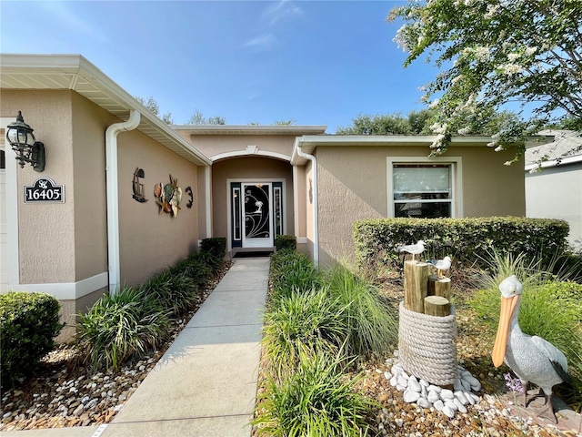 16405 SW 14th Avenue Rd, Ocala, FL 34473 - view of exterior entry with stucco siding