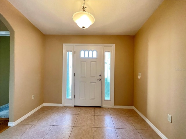 16405 SW 14th Avenue Rd, Ocala, FL 34473 - entryway with arched walkways, light tile patterned floors, and baseboards